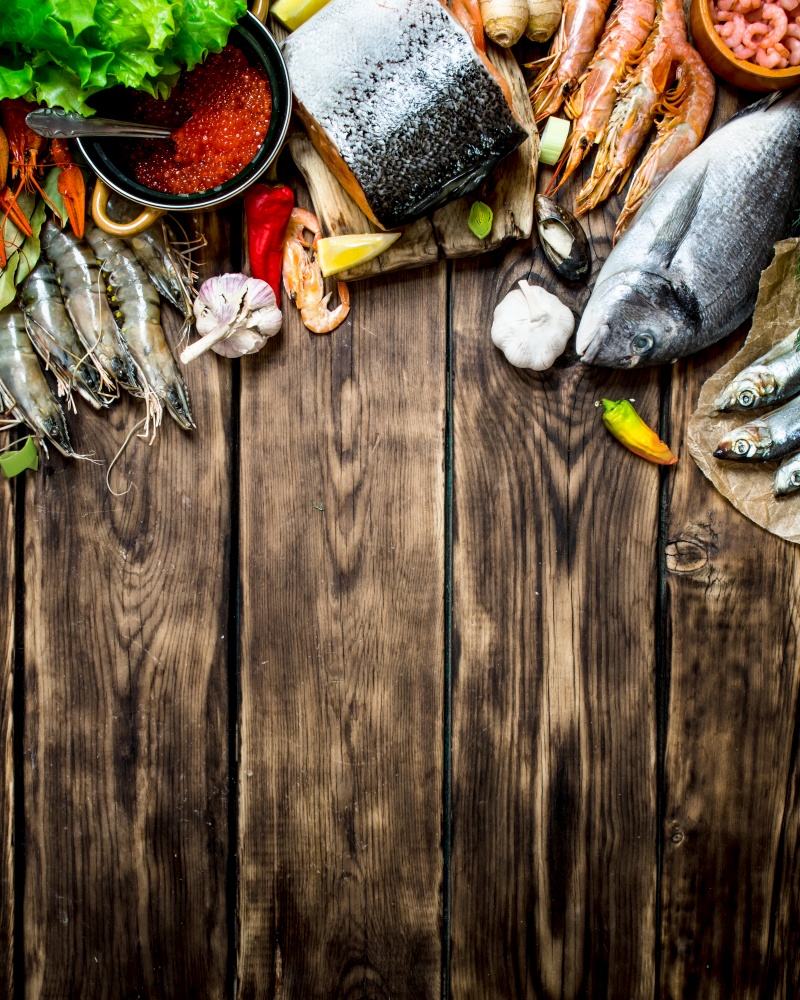 Fresh seafood. A variety of seafood from shrimp, shellfish and other marine life. On wooden background.. variety of seafood from shrimp, shellfish and other marine life.