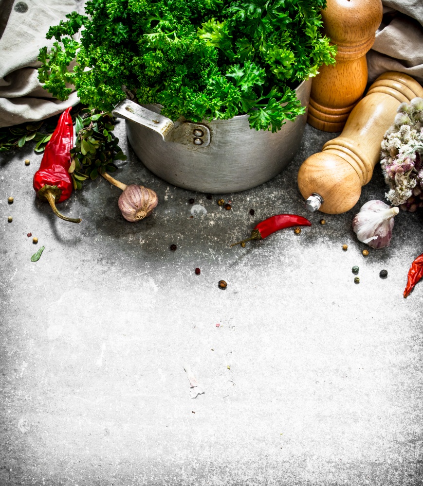 Fresh parsley with spices . On a stone background.. Fresh parsley with spices