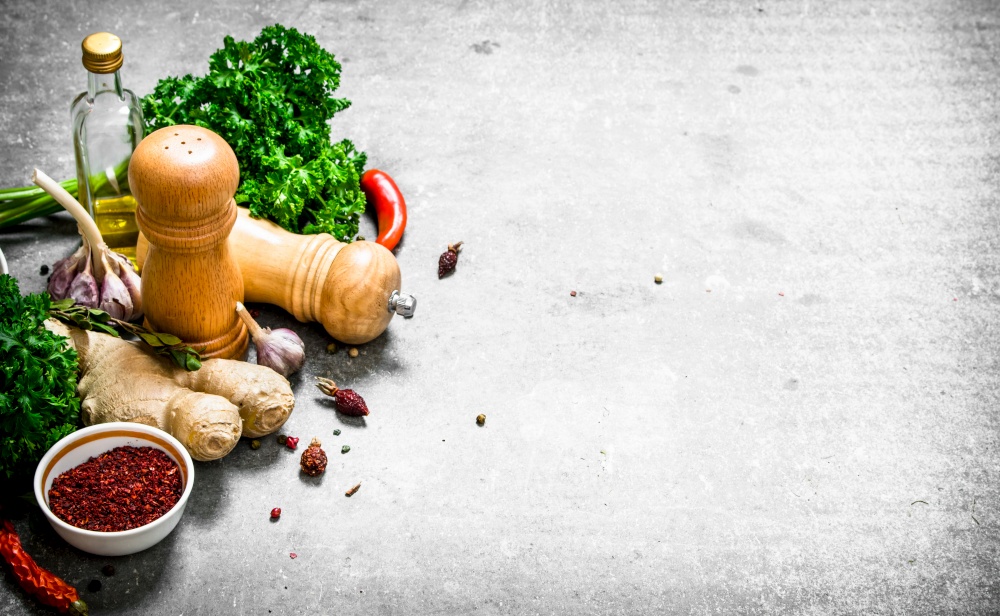set of fresh spices and herbs. On a stone background.. set of fresh spices and herbs