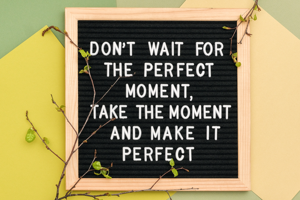 Don&rsquo;t wait for the perfect moment, take the moment and make it perfect. Motivational quote on the frame of the message board and spring branches of trees with young leaves on green background.. Don&rsquo;t wait for the perfect moment, take the moment and make it perfect. Motivational quote on the frame of the message board and spring branches of trees with young leaves on green background