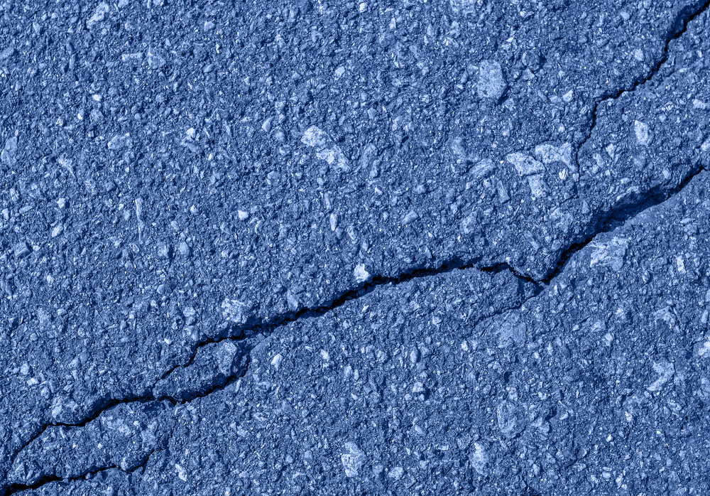 Asphalt with crack background. Old toned blue road for background or texture. Asphalt as abstract background or backdrop. Trendy banner toned in classic blue - color of the 2020 year. Asphalt with crack background. Old toned blue road for background or texture.