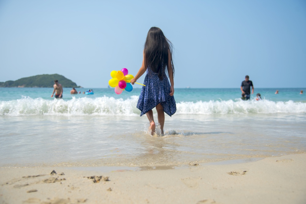 Summer girl play travel in holiday on tropical summer beach. Cheerful Joyful seaside with cute kid vacation on sunny day.