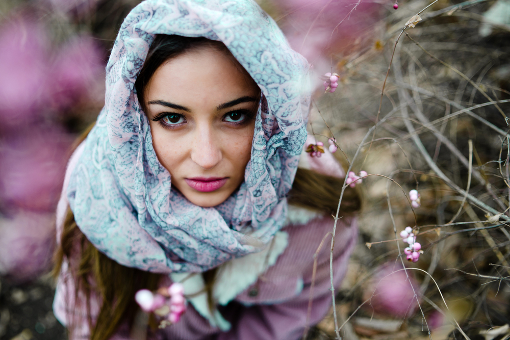Portrait of young woman in nature wearing scarf over Head