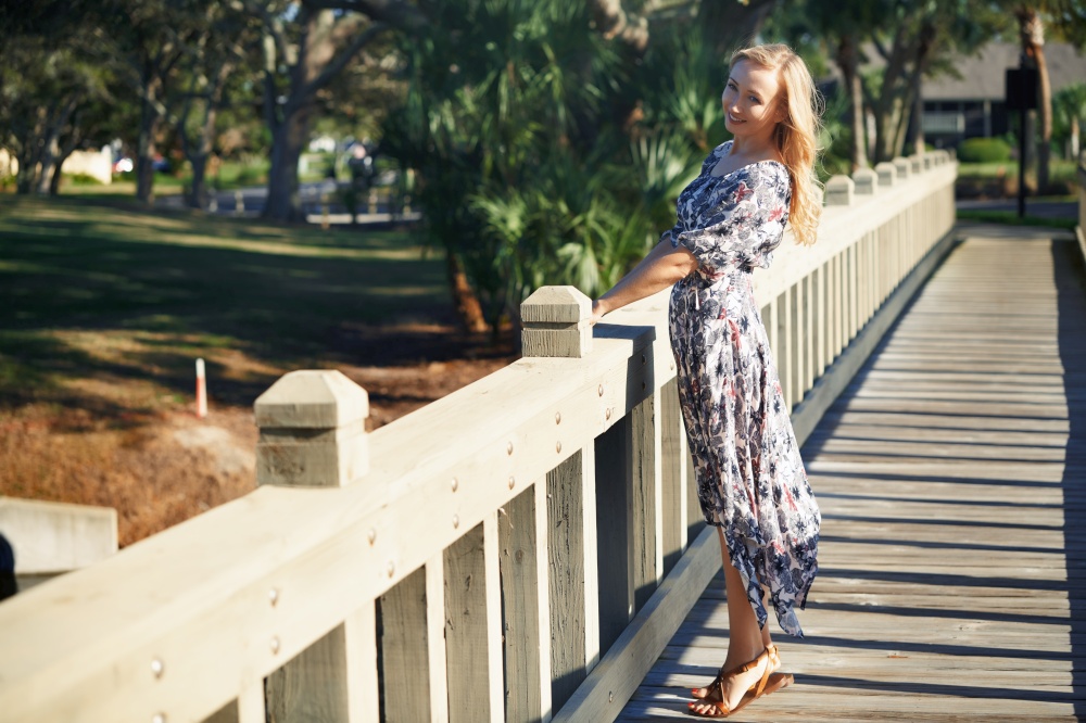 Smiling woman on the wooden bridge