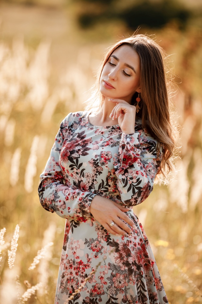 Portrait of beautiful young girl outdoors in spring. young girl in a field.. Portrait of beautiful young girl outdoors in spring. young girl in a field