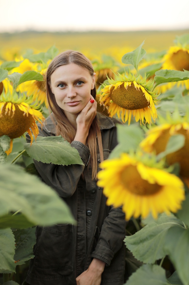 young beautiful woman on blooming sunflower field in summer, health and lifestyle.. young beautiful woman on blooming sunflower field in summer, health and lifestyle