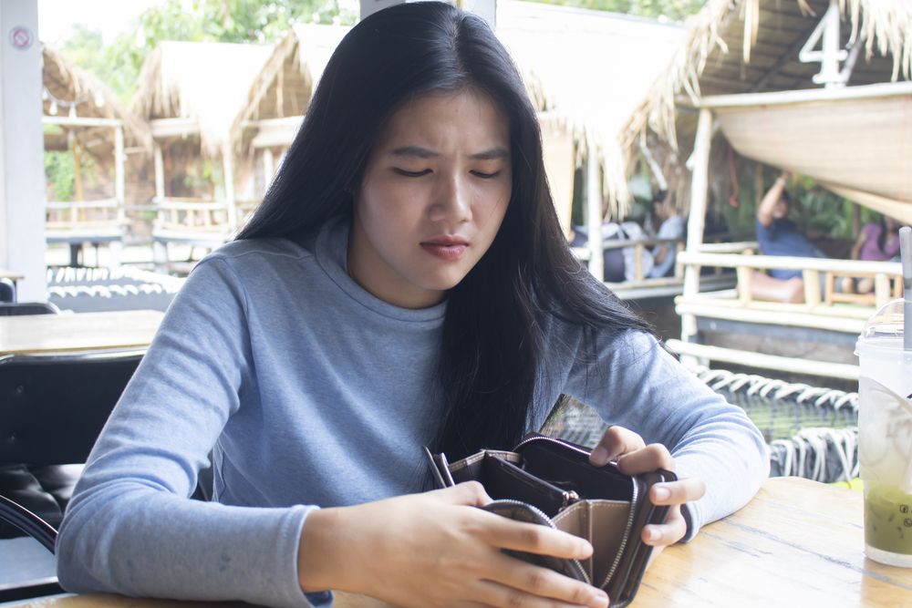 Unhappy Woman Showing Empty Wallet. Financial Failure.
