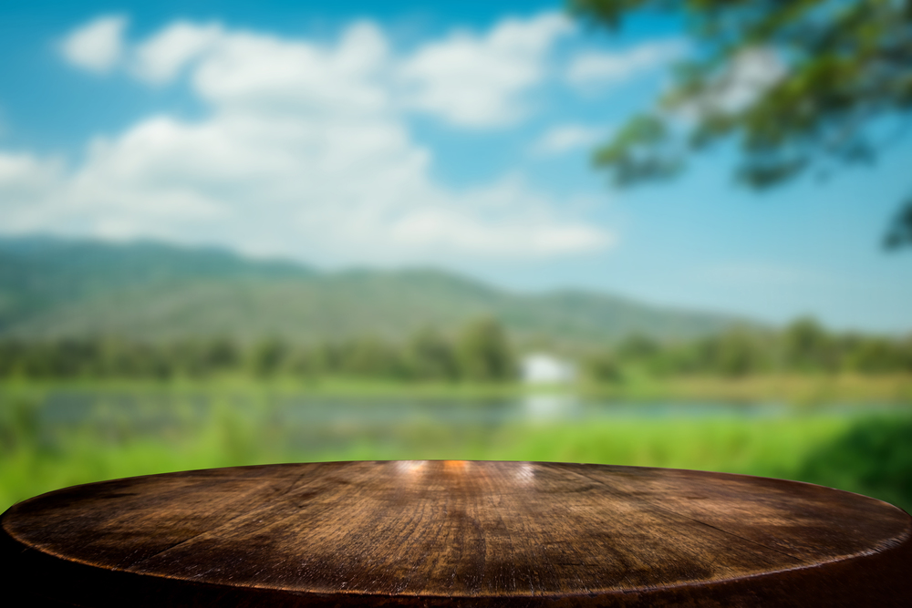 Selected focus empty brown wooden table and blue sky or mountain blur background with bokeh image. for your photomontage or product display.