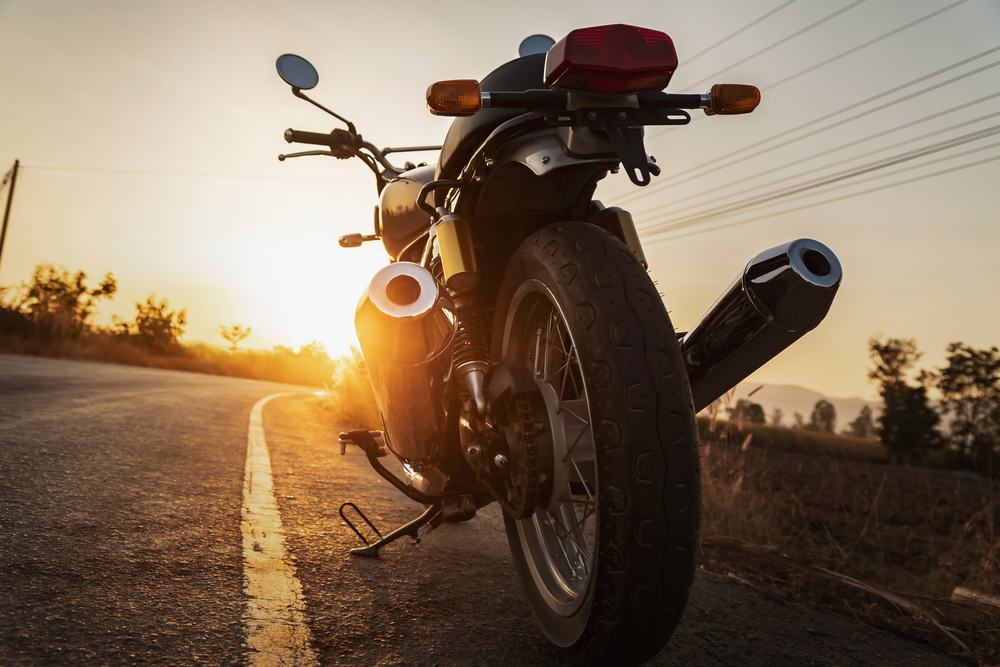 classic style motorcycle on road with sunset