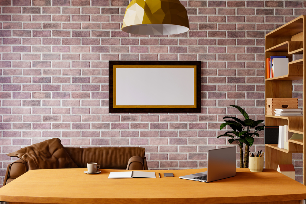 Working room at home. Mock up picture frame on brick wall at workspac.