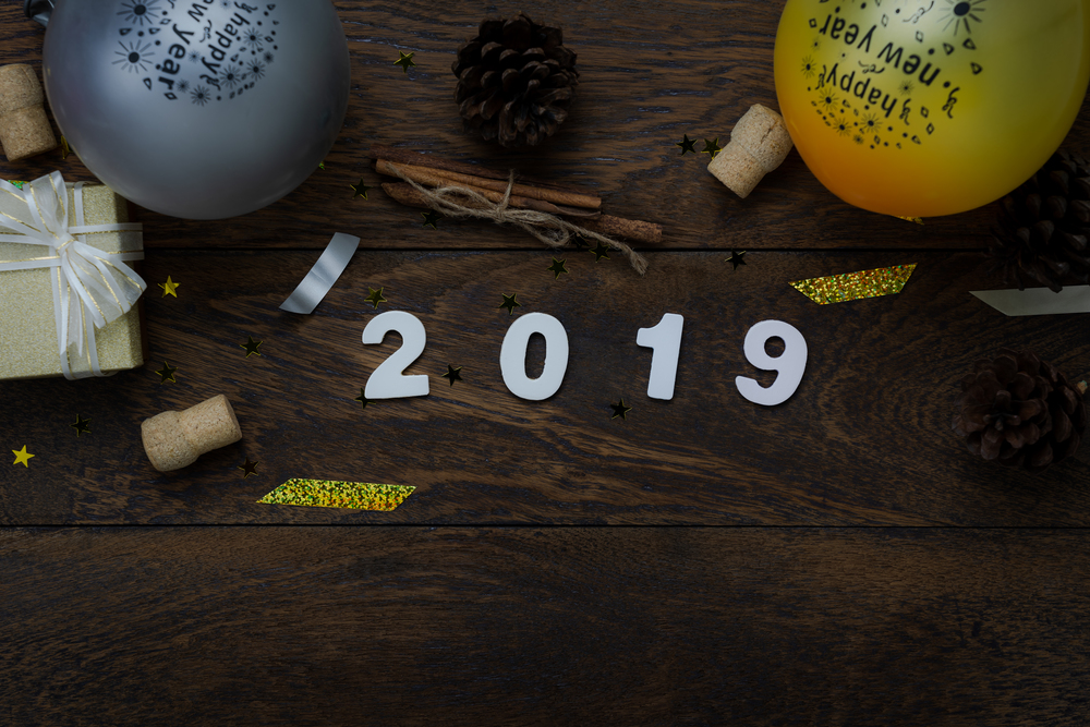 Table top view of Merry Christmas decorations & Happy new year 2019 ornaments concept.Flat lay essential difference objects to party season the photo booth prob on modern wooden brown background.