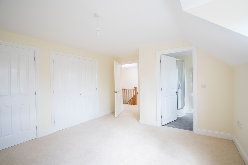 Interior View Of Beautiful Bedroom With Fitted Wardrobes And En Suite Bathroom In New Family House