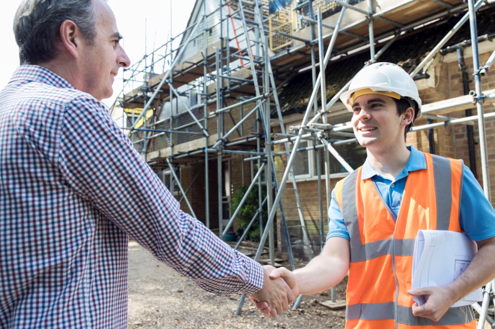 Customer On Site Shaking Hands With Builder