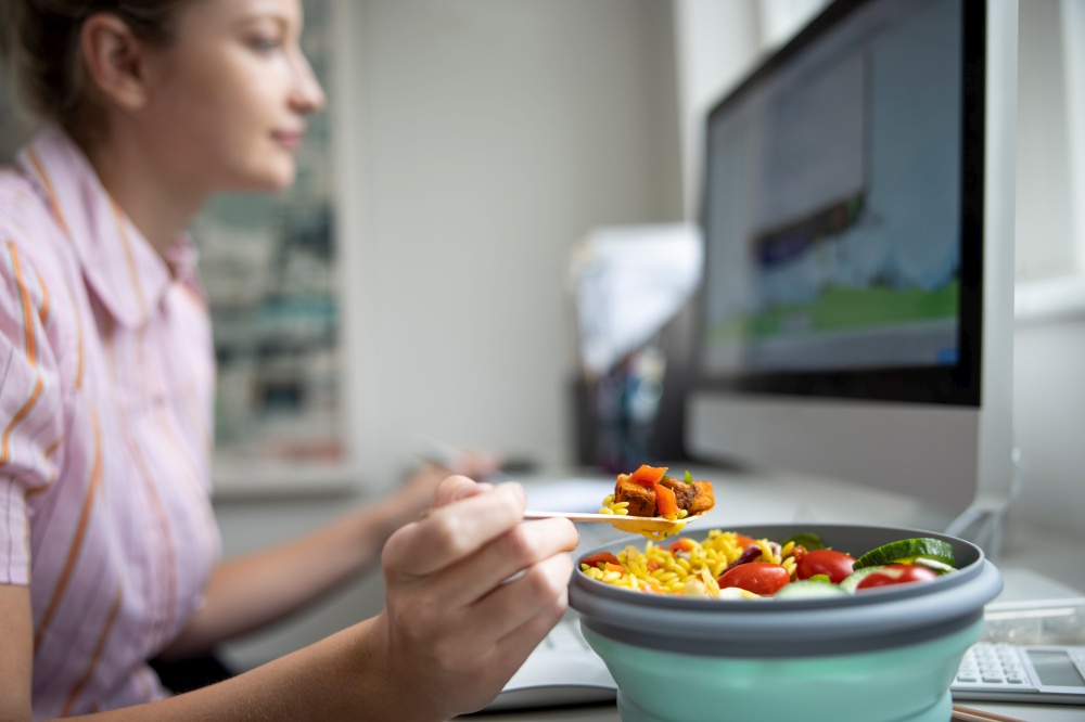 Female Worker In Office Having Healthy Vegan Lunch At Desk