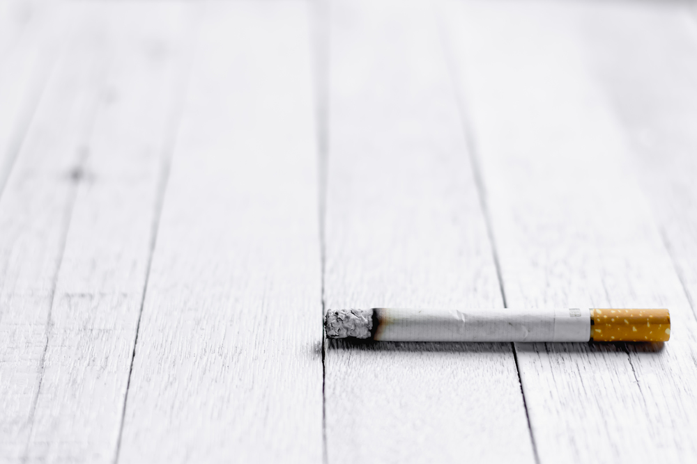 The cigarette is placed on an white wooden floor, World No Tobacco Day concept.