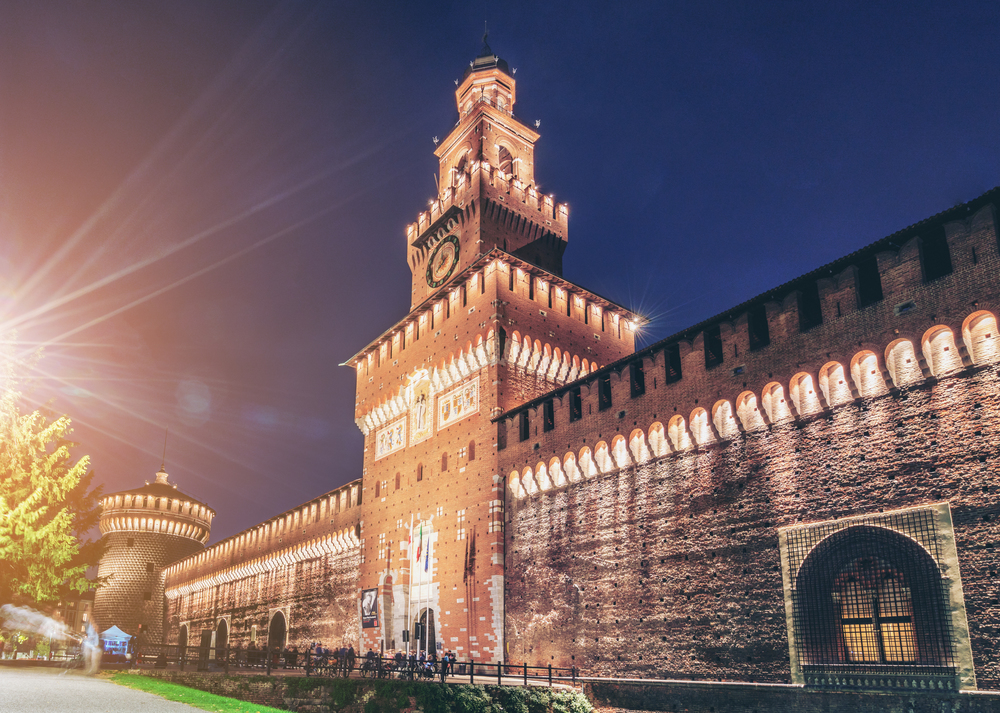 Sforza Castle (Castello Sforzesco) at night in Milan, Italy. The castle was built in the 15th century by Sforza, Duke of Milan. It is the main travel destination for tourist visiting Milan, Italy.