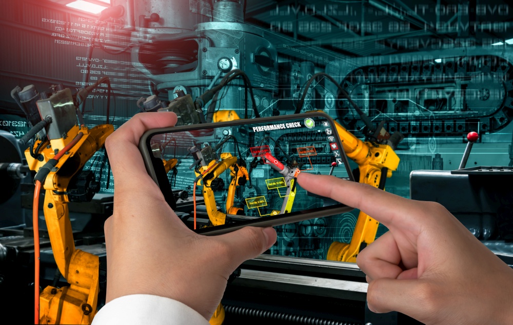 Engineer controls robotic arms by augmented reality industry technology application software. Smart robot machine in future factory working in concept of Industry 4.0 or 4th industrial revolution.