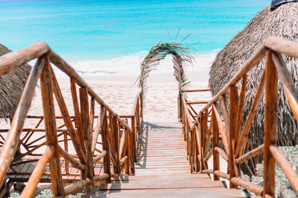 Wooden bridge and turquoise sea ahead. Wooded bridge and turquoise sea on tropical island