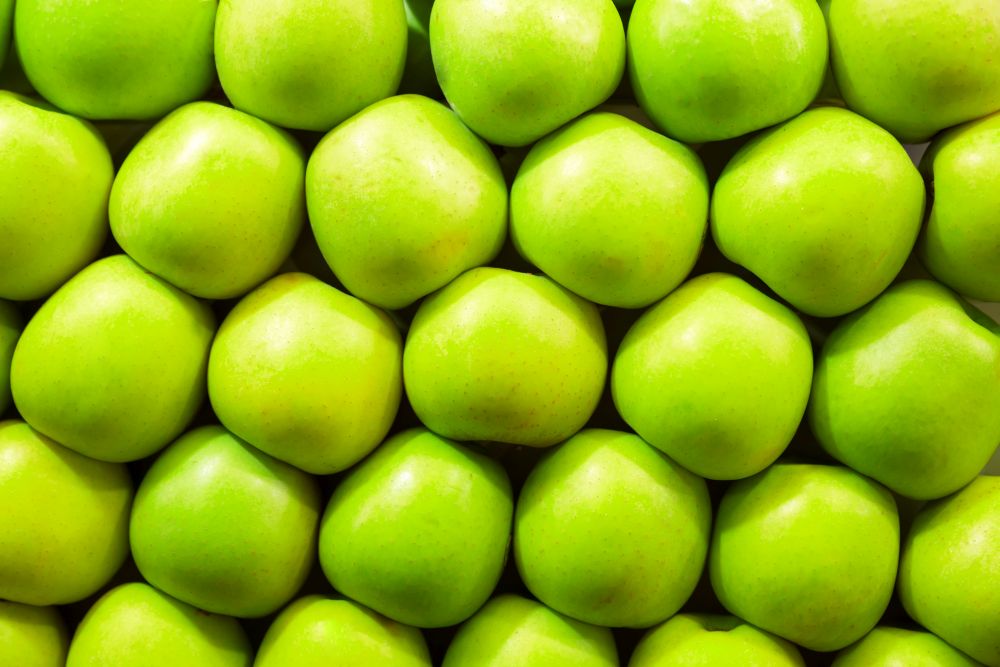 Fresh green apples in a row