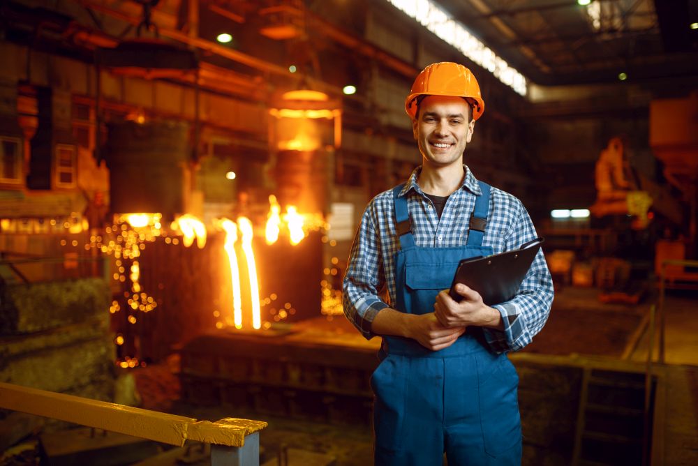 Master in helmet at furnace with liquid metal, steel factory, metallurgical or metalworking industry, industrial manufacturing of iron production on mill. Master at furnace with liquid metal, steel factory