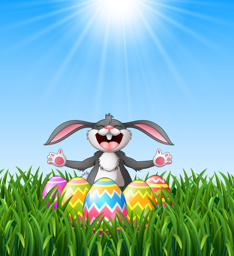 Cartoon rabbit laughing with easter eggs in the grass