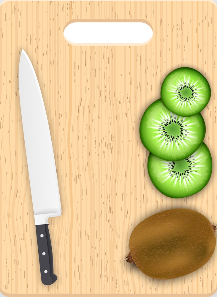 Kiwi slices and knife on the chopping board