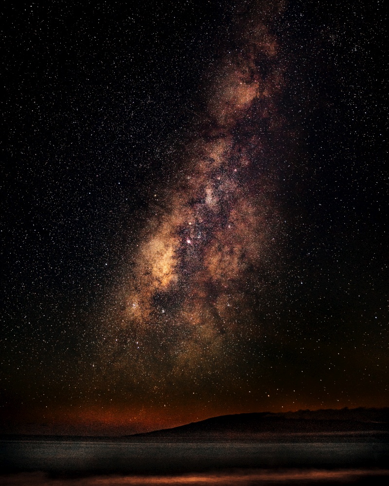 A vertical shot of a sea under a starry sky with milky way. Vertical shot of a sea under a starry sky with milky way