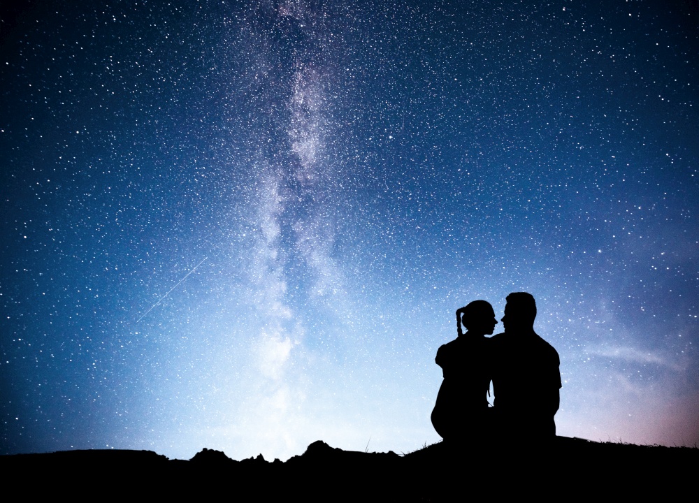 Milky Way with silhouette of people. Landscape with night starry sky. Standing man and woman on the mountain with star light. Hugging couple against purple milky way. Beautiful galaxy. Universe.. Milky Way with silhouette of people. Landscape with night starry sky. Standing man and woman on the mountain with star light. Hugging couple against purple milky way.