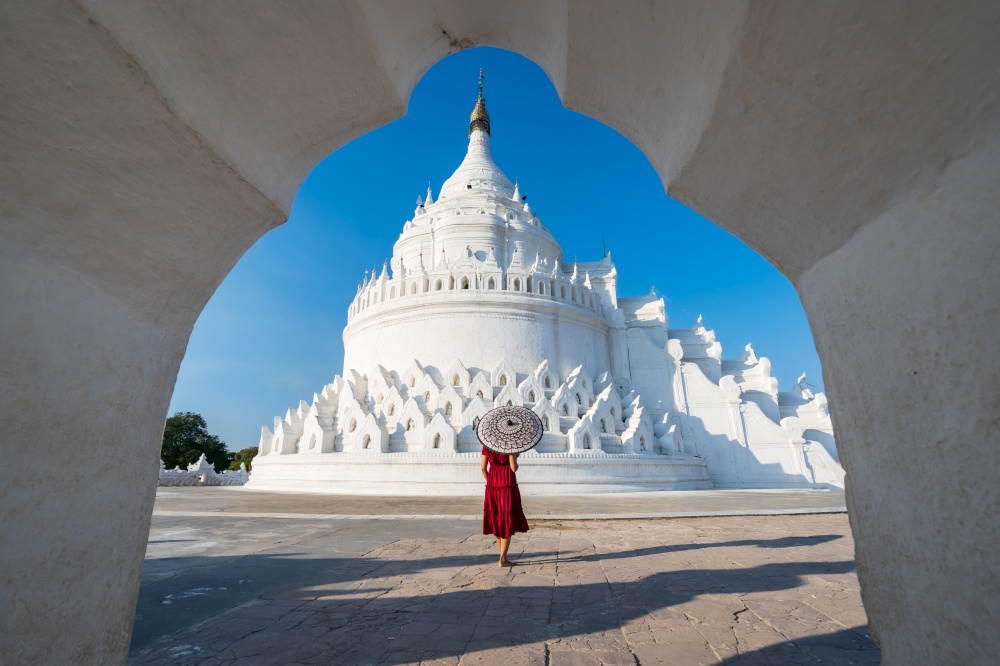 Young woman traveler at Hsinbyume Pagoda (white pagoda) the famous destination in Myanmar