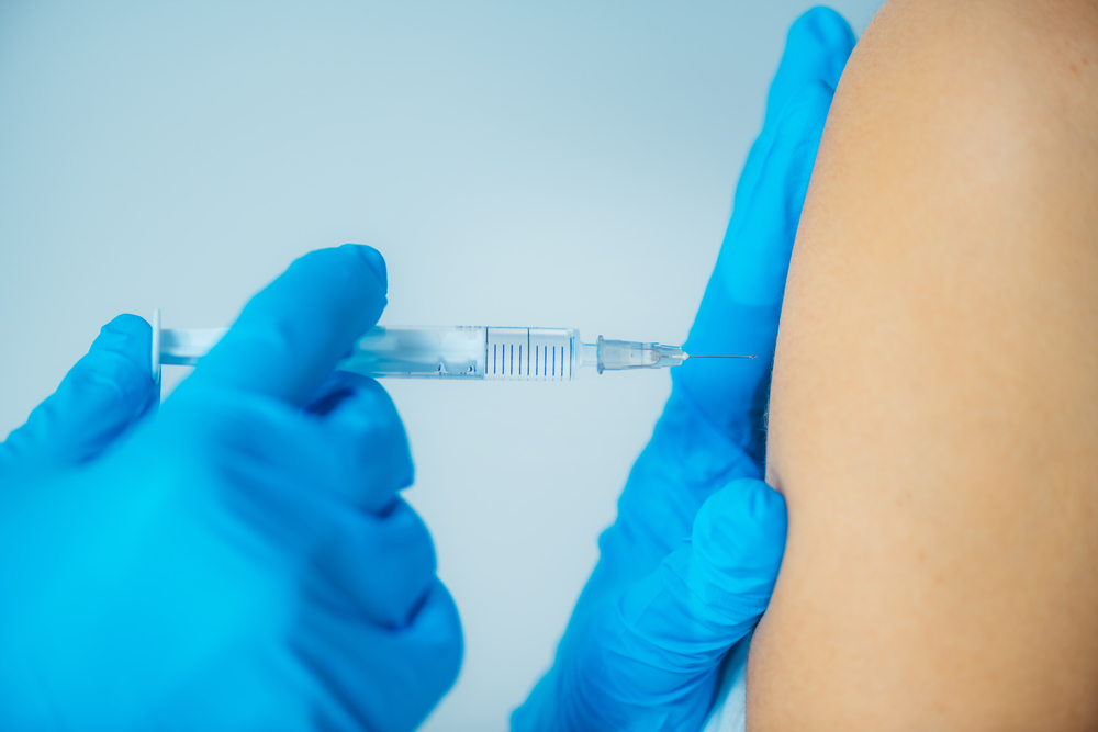 Medical Professional Administering a Flu Vaccine. Woman Getting a Flu Vaccine