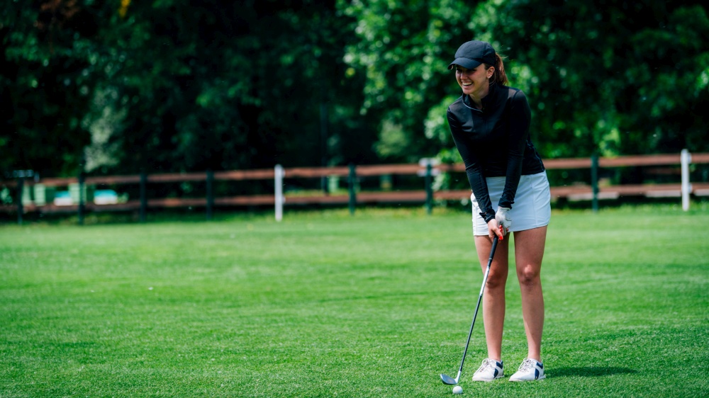 Young woman playing golf on a golf course