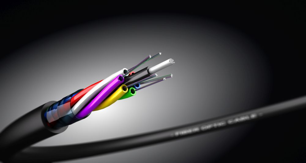Stripped fiber optic cable over black background with spot light, communication network technology. . Fiber Optic Cable