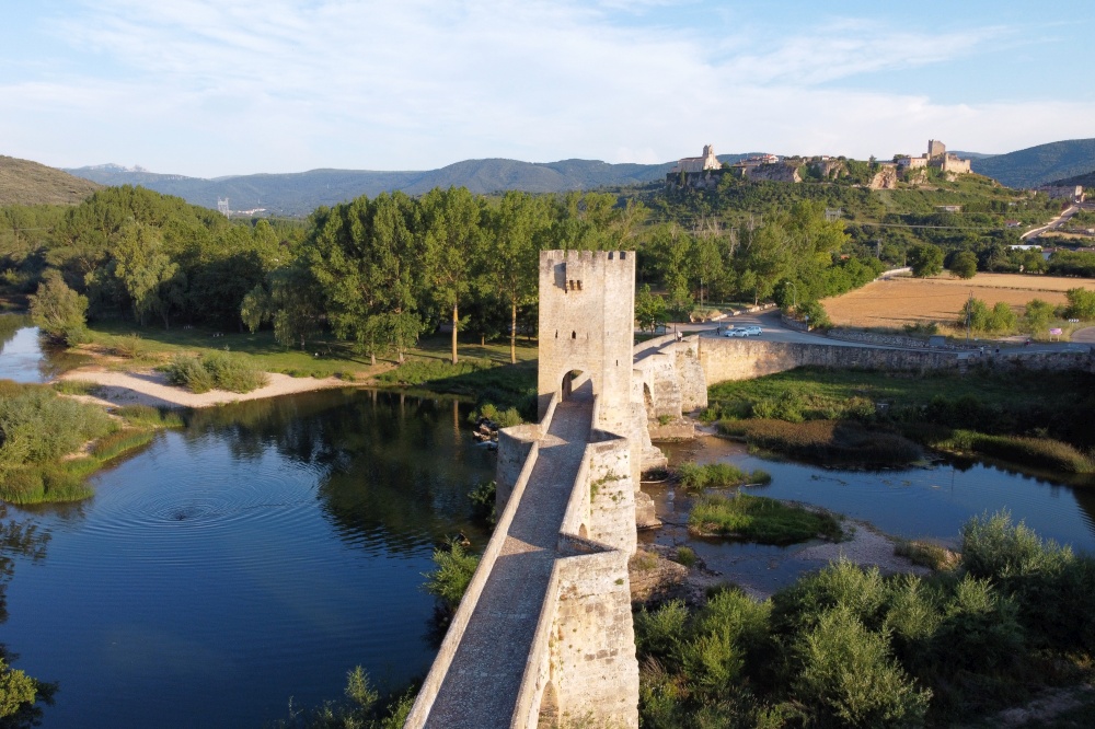 Aerial view of a medieval stone bridge over Ebro river in Frias, historic village in the province of Burgos, Spain. High quality 4k footage. Aerial view of a medieval stone bridge over Ebro river in Frias, historic village in the province of Burgos, Spain