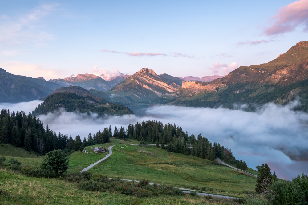 Sea clouds by a lake in the mountains in the French Alps.