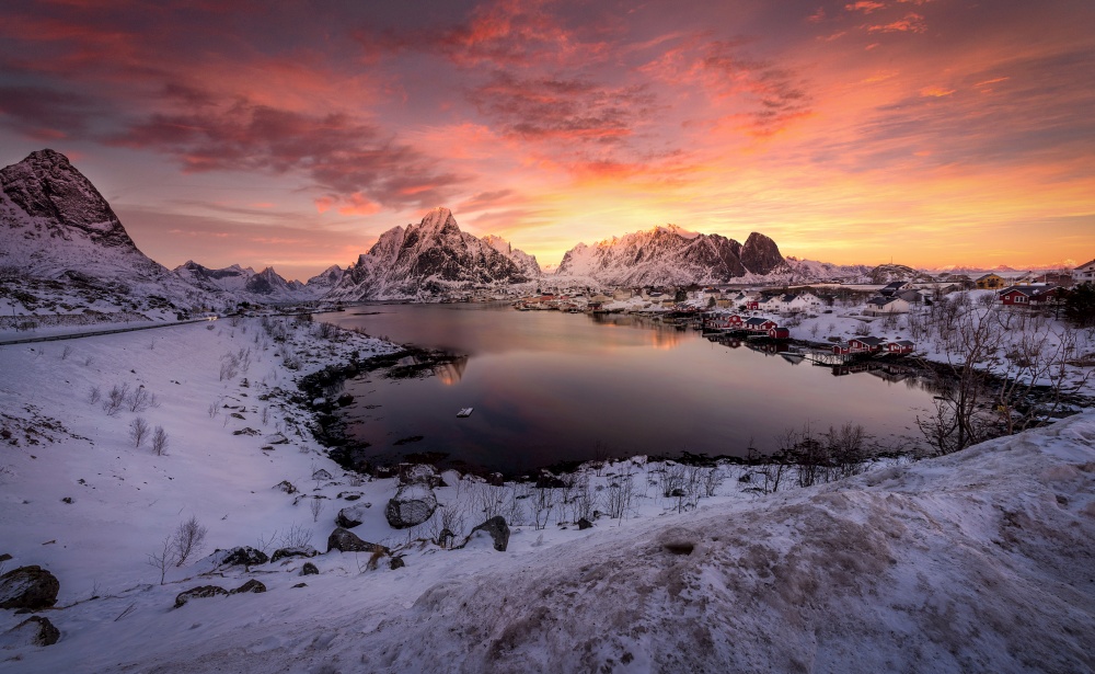 Village Hamnoy Reine with snow and mountains in the Arctic, Lofoten Islands in Norway at sunset, Scandinavia