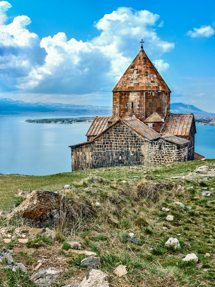 View of Sevanavank monastery and Sevan lake surrounded by snowy mountains in Armenia