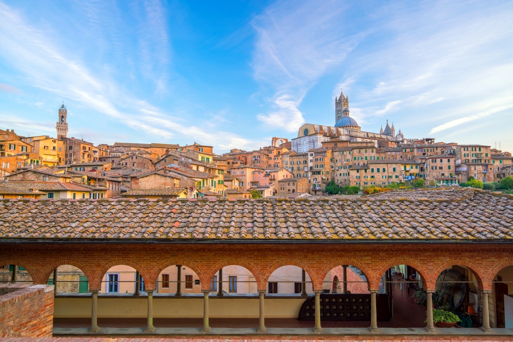 Downtown Siena skyline in Italy with morning blue sky