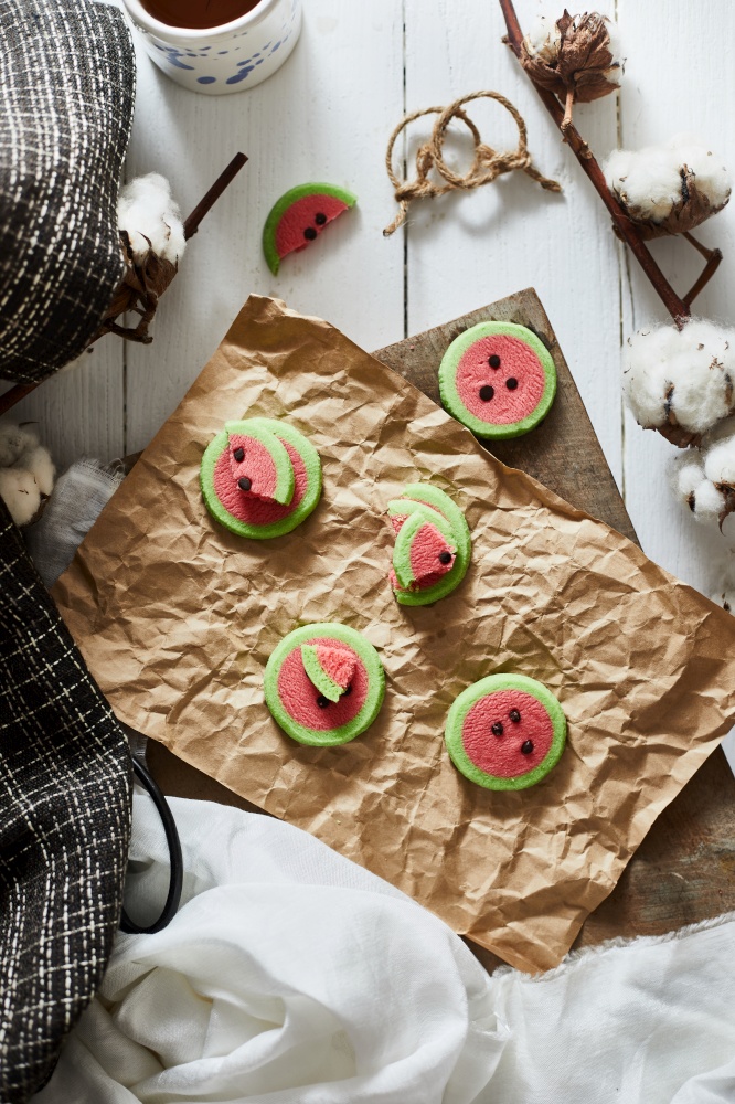 Watermelon slice cookies recipe on background.