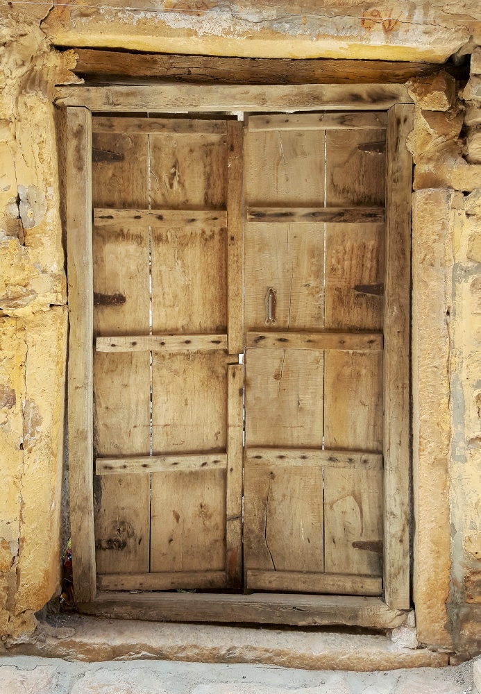 Antique rustic ancient wooden door. Architectural element.. Antique rustic ancient wooden door.