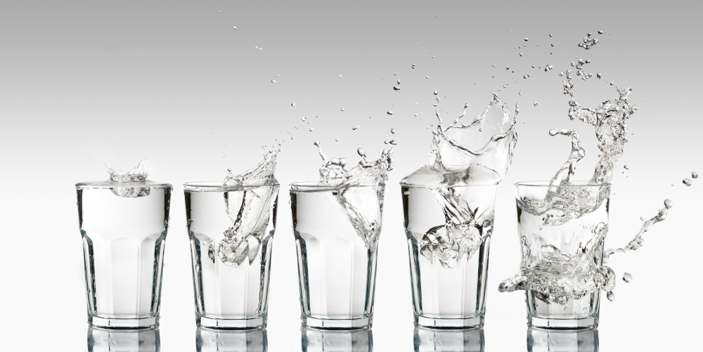 Intensity growth represented with a progression of different splashes on a glass of water