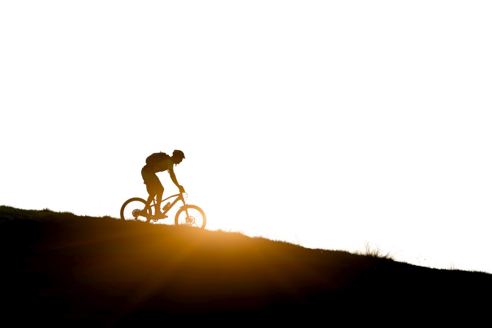 Cyclist in the mountains  downhill mountain bike in silhouette