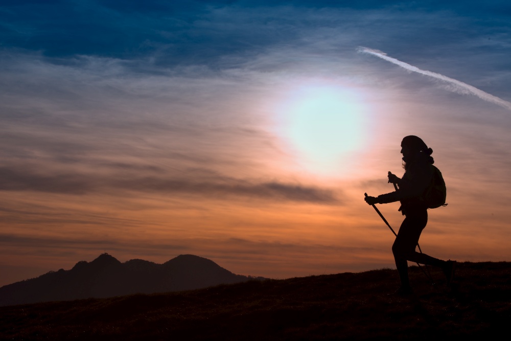 Woman Hiking in the Mountains at Sunset  Outdoor Adventure  Active Lifestyle