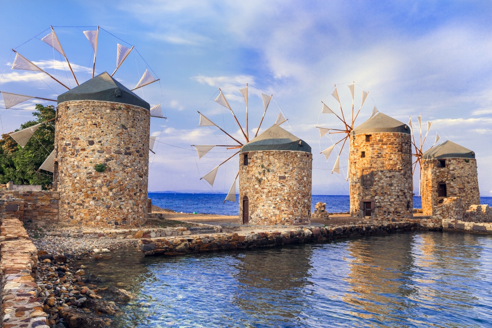 Authentic traditional Greece scenery - old windmills near the sea - landmark of Chios island. Greek windmills. Chios island