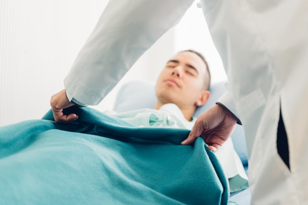 Hands man doctor using blanket to patient, selective focus