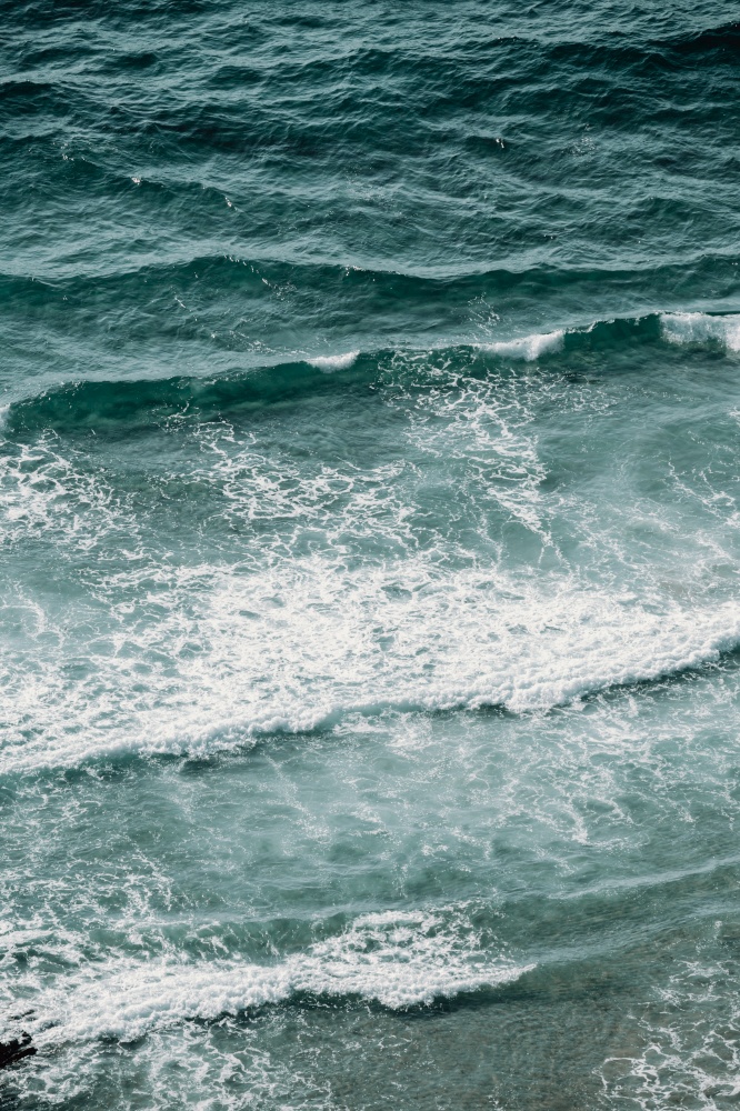 An aerial view of the waves in the middle of the sea