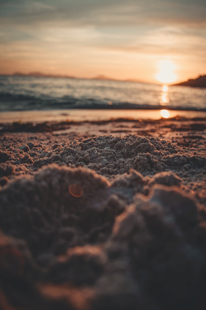 The sand of the beach during a sunset