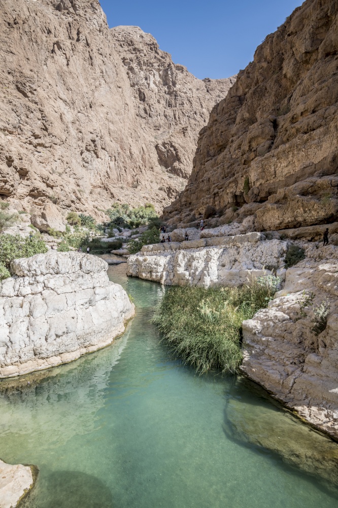 People in the canyon of the famous and touristic Wadi Shab, Tiwi, Sultanate of Oman, Middle East. River of Wadi shab, Oman