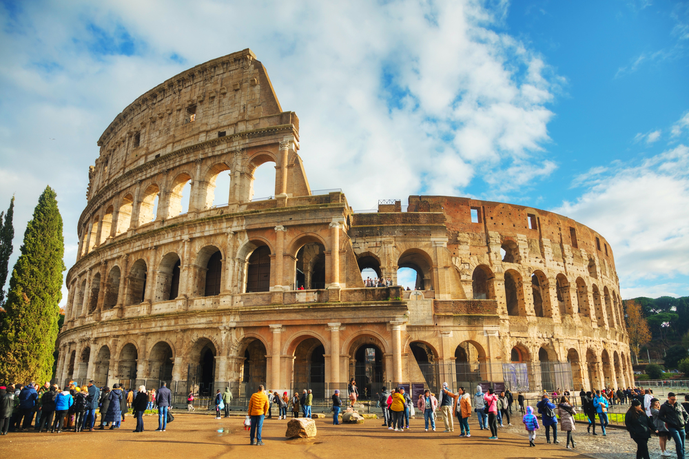 ROME - DECEMBER 12: The Colosseum or Flavian Amphitheatre with people on December 12, 2019 in Rome, Italy.