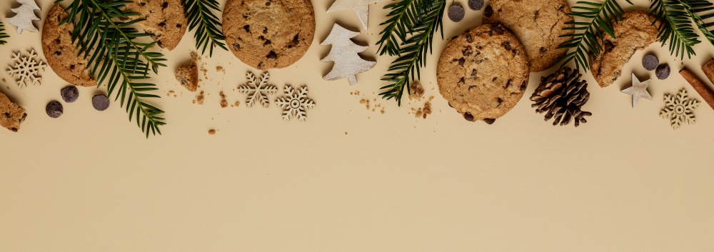Christmas background with Chocolate chip cookies and wooden decorations, flat lay, top view. Eco friendly, zero waste Christmas