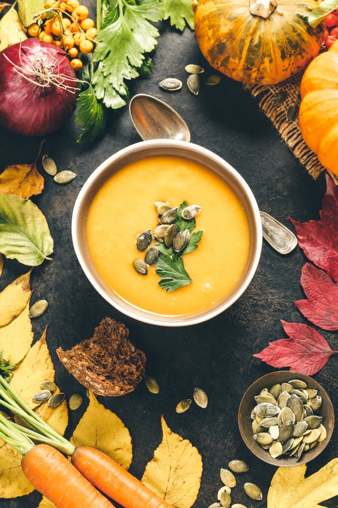 Pumpkin soup in a bowl on rustic surface. Pumpkin soup in a bowl, flat lay